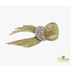BROCHES / ALFILERES Broche-alfiler lazo con medialuna en oro amarillo y oro blanco con diamantes.