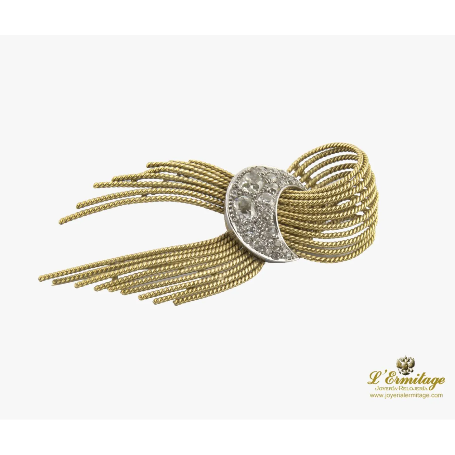 BROCHES / ALFILERES Broche-alfiler lazo con medialuna en oro amarillo y oro blanco con diamantes.