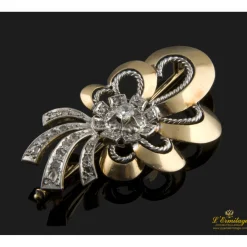 BROCHES / ALFILERES Broche en oro amarillo y oro blanco con un brillantes y diamantes.
