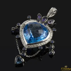 COLGANTES Colgante realizado en oro blanco. Presenta un piedra azul principal con orla de brillantes.