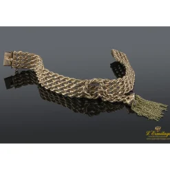 PULSERAS Pulsera realizada en oro rosa y oro amarillo con forma de cuatro trenzas en fila con un nudo y flecos.