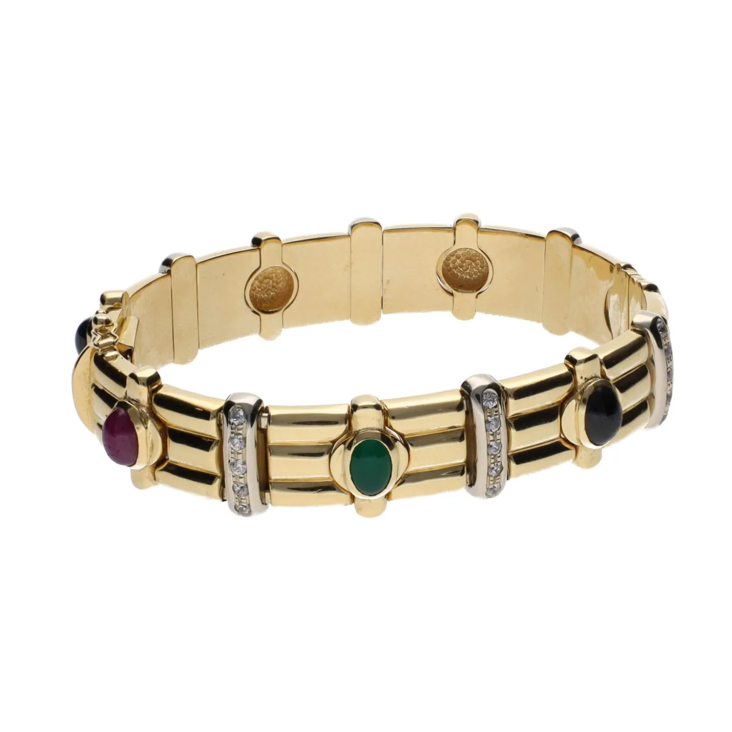 PULSERAS Pulsera rígida en oro amarillo con zafiros, rubíes, esmeraldas y brillantes.